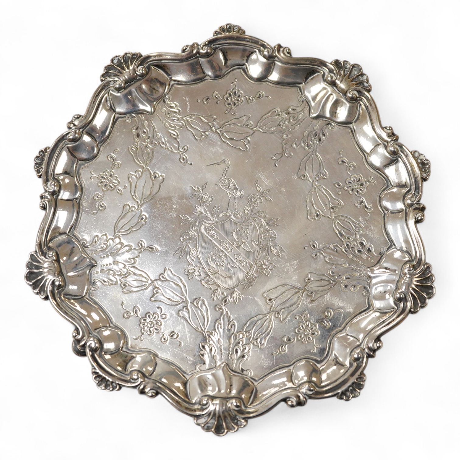 A George III silver waiter, John Cox, London, 1771, of shaped circular form, with later decoration, on three hoof feet, 16.7cm, 7.2oz.